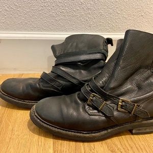 Well worn black leather motorcycle style boots